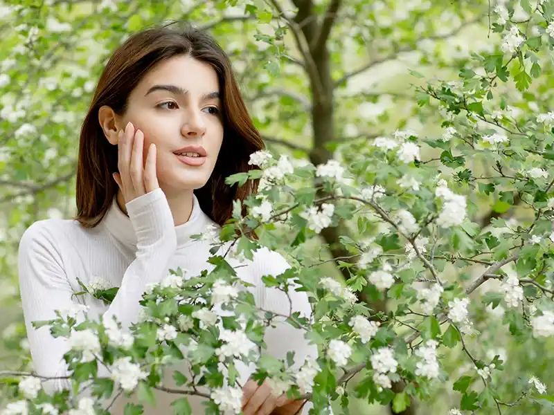 Una chica en la naturaleza con la piel cuidada. Imagen representativa de cosmética natural.